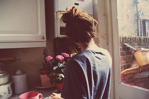 a woman standing in front of a kitchen counter with a pink cup on it and the words, i just want to have every and leave it behind me