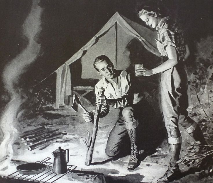 two men standing next to each other in front of a campfire with a tent