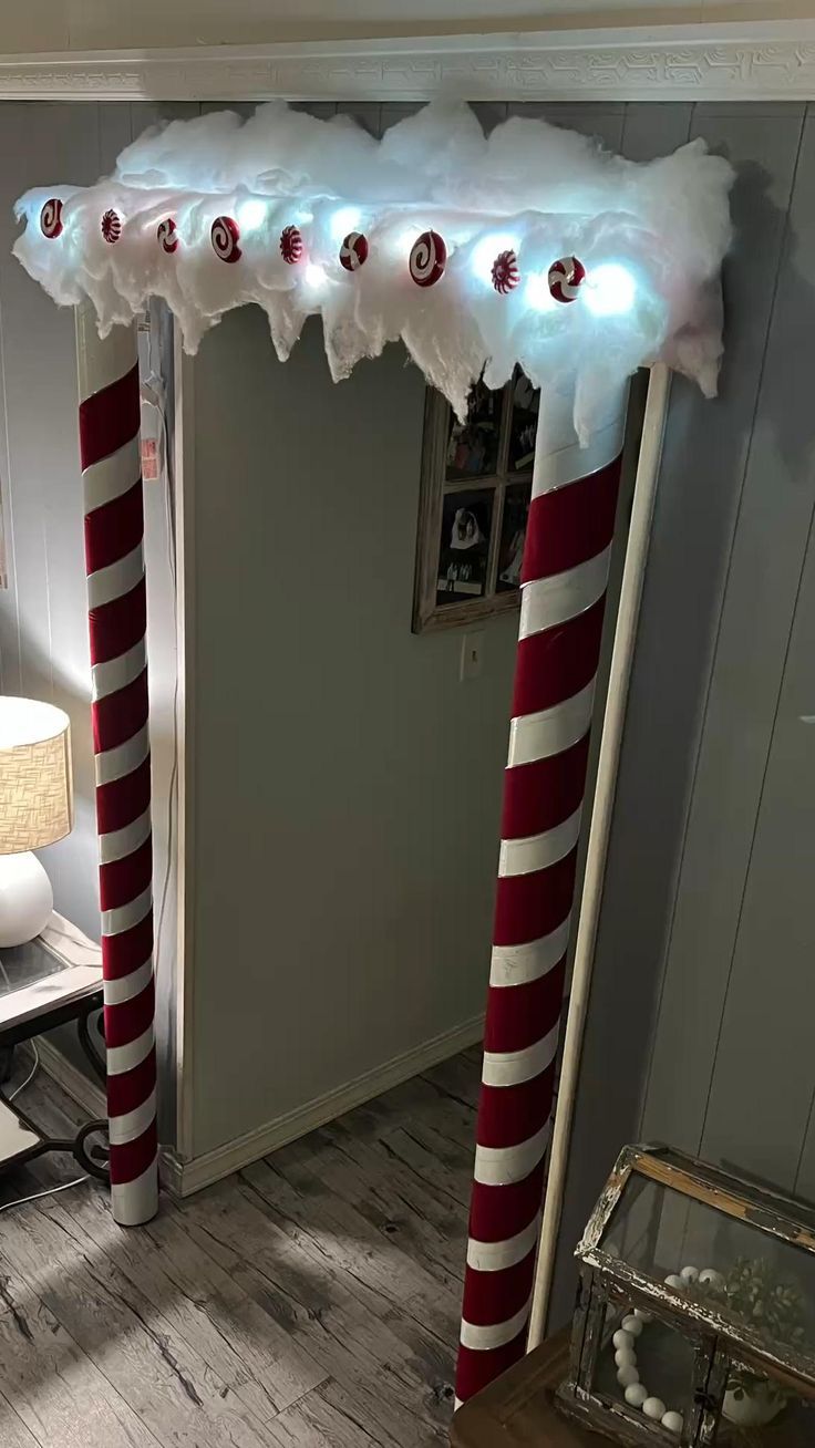 an arch decorated with candy canes and lights in the corner of a living room