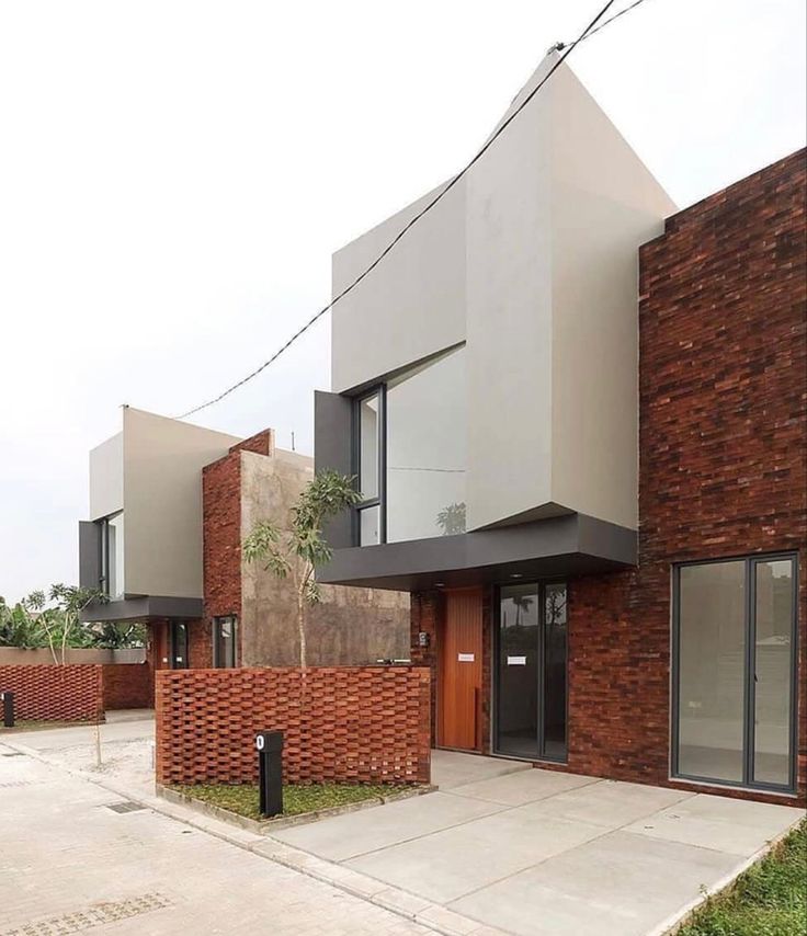 the building is made of brick and has two stories on each level, along with an attached parking lot