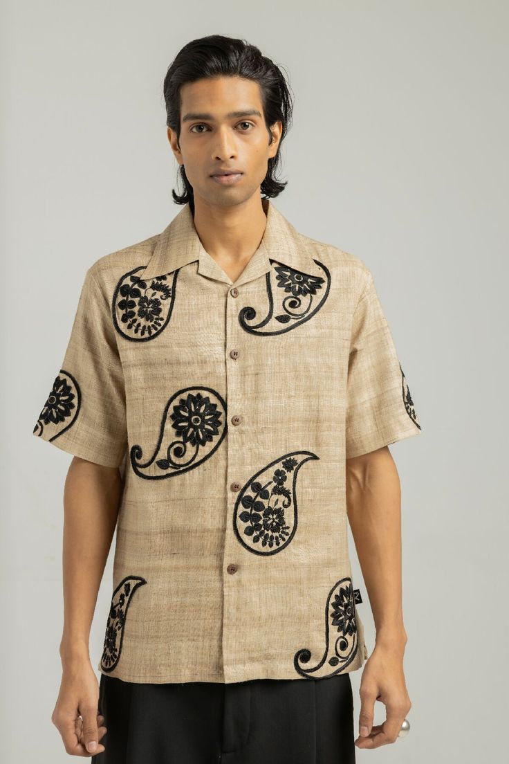 Welcome to Zero Tolerance's latest offering: the Kairi Handmade Shirt, a testament to exquisite craftsmanship and timeless elegance. Meticulously crafted using handwoven and hand spun fabric sourced from the esteemed Bhagalpur region of Bihar (India), each shirt is a masterpiece in itself.Embodying the rich heritage of India's textile traditions, the Kairi Handmade Shirt features a stunning Zardozi worked paisley print adorning its entirety. This ancient embroidery technique, with roots dating back over 3000 years in the Lucknow region, is skillfully executed by generational artisans, infusing every thread with a sense of history and artistry.Combining traditional craftsmanship with contemporary style, the Kairi Handmade Shirt exudes sophistication and refinement. Each shirt undergoes a me Elegant Cotton Tops With Printed Motifs, Formal Cotton Kurta With Printed Motifs, Traditional Embroidered Shirt For Formal Occasions, Traditional Festive Shirt For Formal Occasions, Traditional Relaxed Fit Kurta For Festive Occasions, Festive Traditional Kurta With Relaxed Fit, Traditional Cotton Shirt For Festive Season, Festive Cotton Shirt With Resham Embroidery, Festive Traditional Shirt With Resham Embroidery