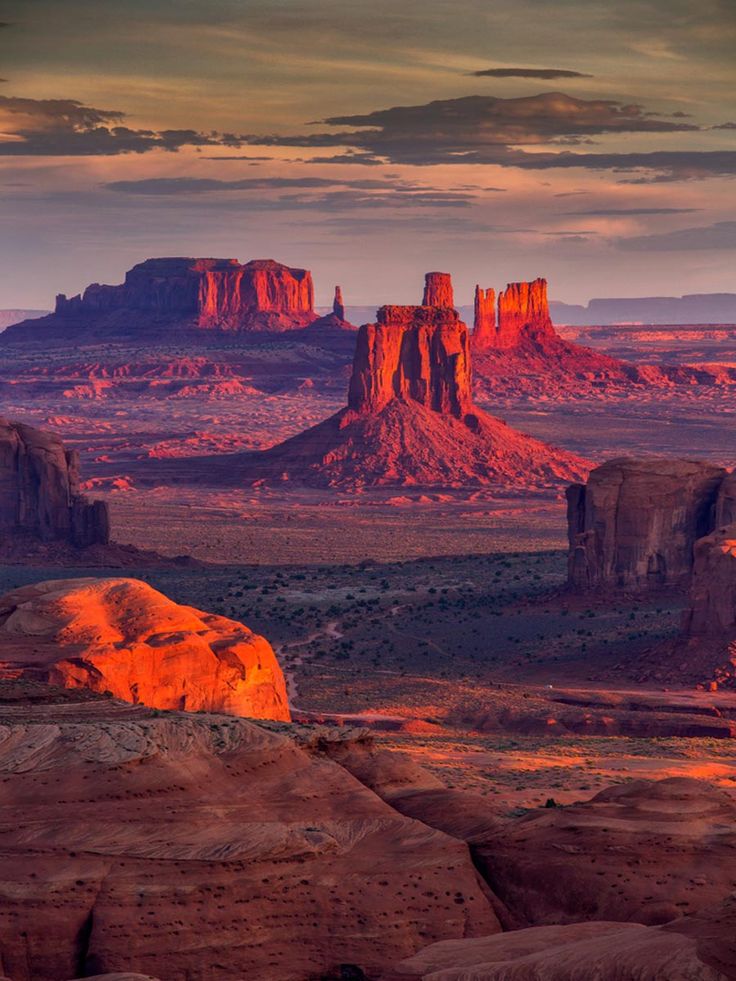 the desert is full of rock formations at sunset