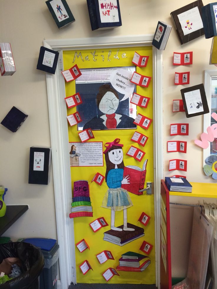 a door decorated with books and pictures on the front, along with other school decorations