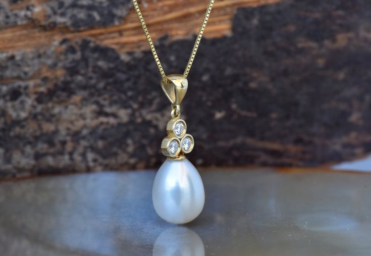 Xmas gift-Pearl necklace-Art deco pearl pendant- Bridal necklace pearls-Single pearl necklace-Diamond & Pearl-Anniversary gift-For her Anniversary gift for her-Birthday present -FREE SHIPPING Do you need beautiful pearl necklace for a special occasion? These gorgeous diamond and pearl pendant would make a perfect classic accent for a bride on her wedding day or an accessory for formal evening events. These pearl pendant are made with 14K yellow gold, 0.10 carat diamonds, and lovely freshwate Refined Yellow Gold Pearl Necklace For Wedding, Elegant Yellow Gold Pear-shaped Pearl Necklace, Elegant Pear-shaped Yellow Gold Pearl Necklace, Timeless Pear-shaped Wedding Necklace, Timeless Pearl Drop Necklace For Anniversary, Elegant Yellow Gold Pearl Necklace For Wedding, Classic Pearl Necklace With Diamond Accents For Wedding, Classic Diamond Pearl Necklace For Wedding, Classic Wedding Pearl Necklace With Diamond Accents