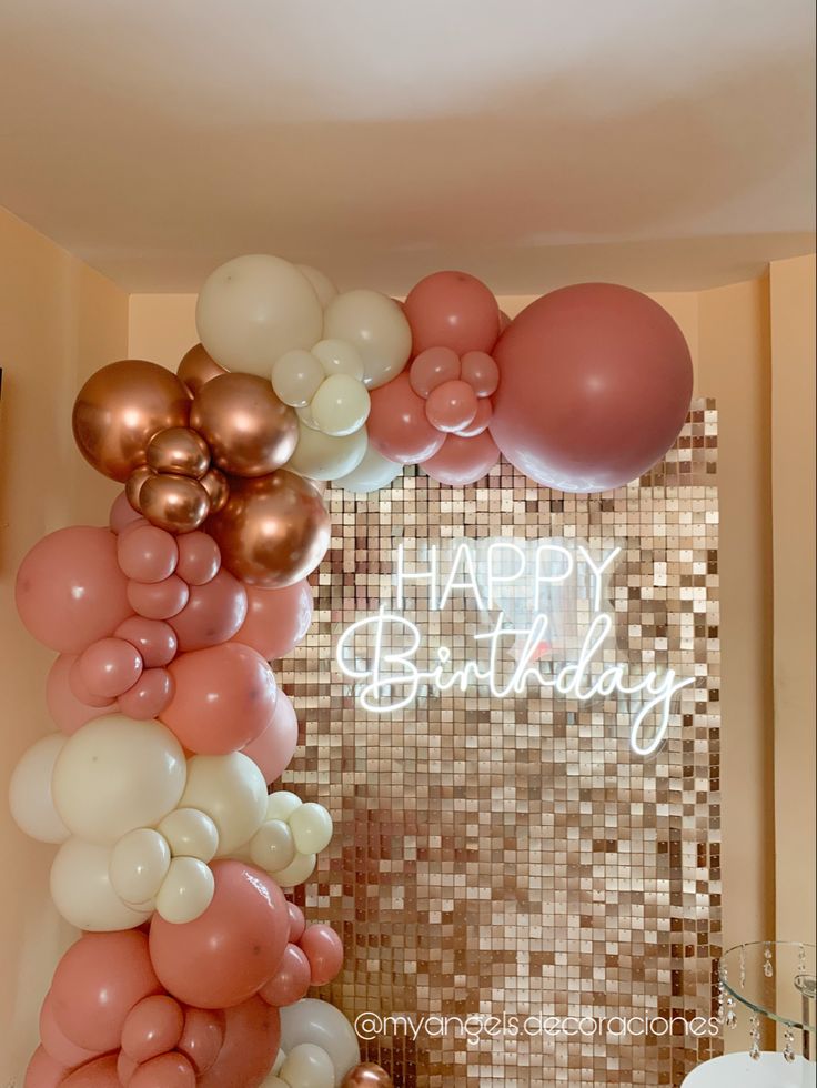 a birthday party with balloons and streamers in the shape of a happy birthday sign