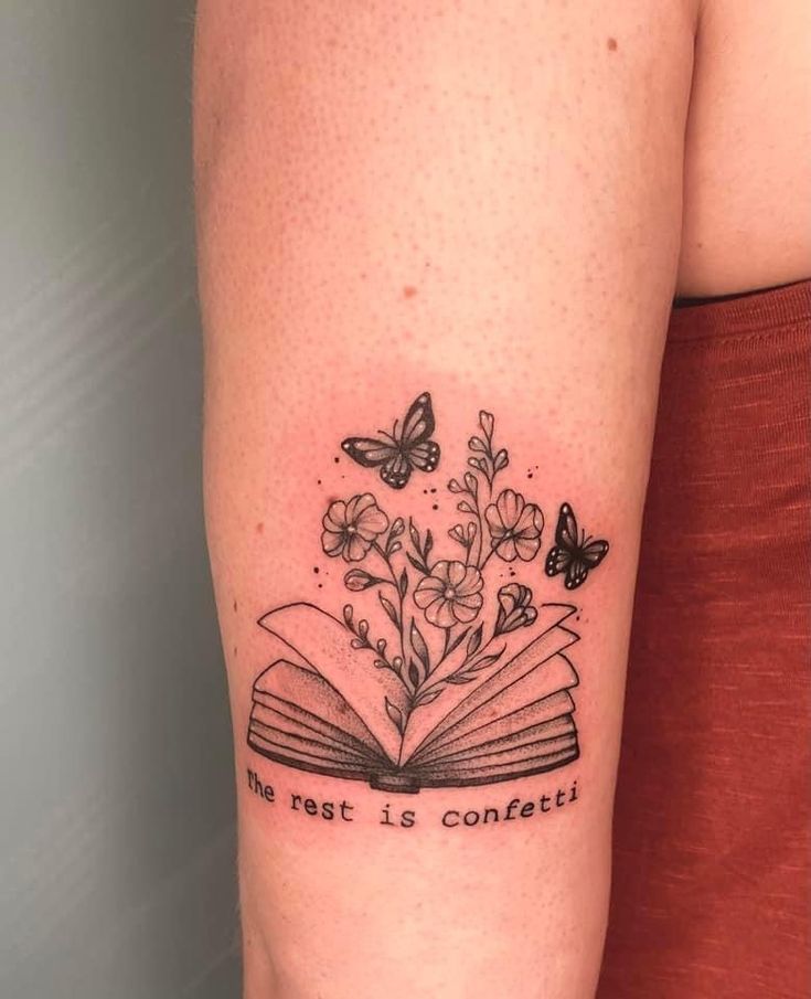 a woman's arm with an open book and butterflies on it that says, the rest is contemplative