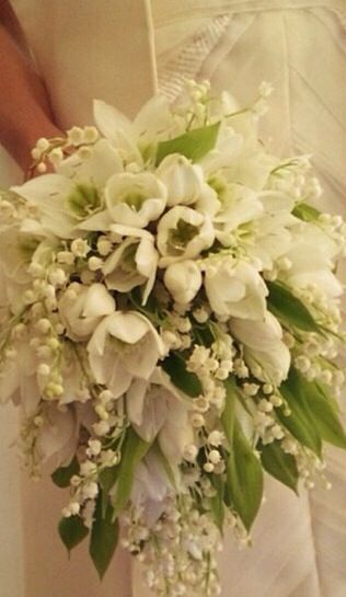 a bridal holding a bouquet of white flowers