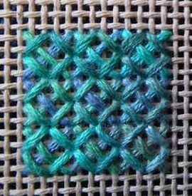 a close up of a piece of cloth with some blue and green squares on it