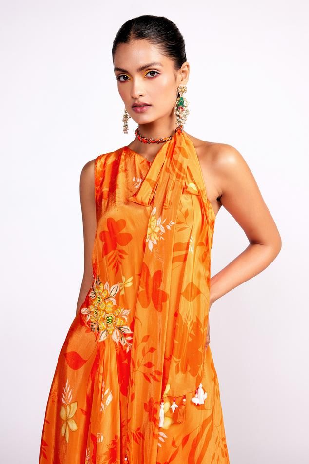 Orange asymmetric floral print tunic, highlighted with placement floral embroidery in sequins and cutdana. Paired with a floral print sharara and scarf dupatta.
Components: 3
Pattern: Print
Type Of Work: Floral
Neckline: Asymmetric Neck
Sleeve Type: Sleeveless
Fabric: Crepe, Lining: Crepe
Color: Orange
Other Details: 
Model height: 5ft 8 inches, wearing size S
Note: Hair accessory worn by the model is not for sale
Occasion: Sangeet - Aza Fashions Sheer Dupatta Palazzo Set For Festive Summer, Festive Palazzo Set With Sheer Dupatta For Summer, Traditional Drape Summer Dress With Pallu, Sleeveless Silk Dress For Diwali, Summer Festive Palazzo Set With Sheer Dupatta, Summer Dresses With Traditional Drape And Pallu, Designer Wear Summer Sharara With Traditional Drape, Sleeveless Palazzo Set With Sheer Dupatta For Diwali, Sleeveless Silk Festival Dress