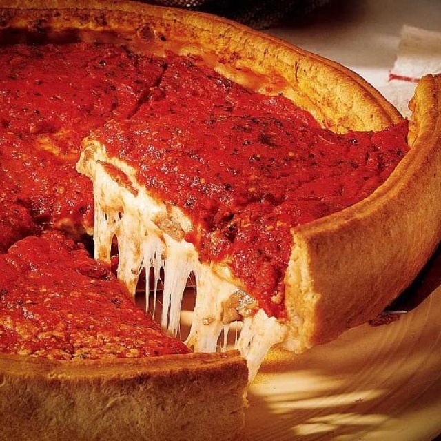 a deep dish pizza with cheese and sauce