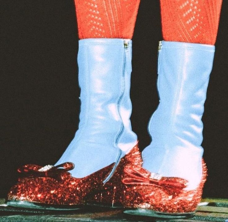 a pair of shiny blue and red shoes with sequins on them are shown in front of a black background