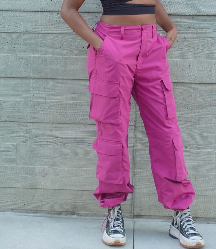 •Model is wearing size small •Material: 100% Polyester •Style Guide: These women's "Ready To Roll Cargo Pants" are designed to provide a relaxed, yet stylish look. Constructed with a drawstring at the hem and side pockets along the side for convenience, they are the perfect touch for casual days. Create a chic outfit by pairing them with either a corset, basic, or sweater. Pink Utility Cargo Style Bottoms, Pink Cargo Style Pants For Streetwear, Pink Utility Pants For Streetwear, Spring High-waisted Harem Pants With Cargo Pockets, Pink Cotton Utility Parachute Pants, Pink Utility Wide Leg Parachute Pants, Pink Wide Leg Utility Parachute Pants, Casual Pink Parachute Pants With Cargo Style, Trendy Pink Parachute Pants With Side Pockets