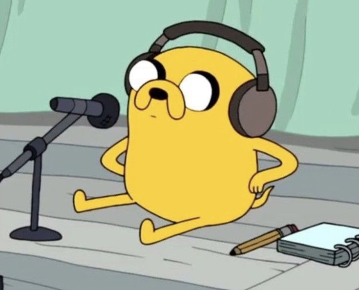 a cartoon character with headphones sitting in front of a microphone