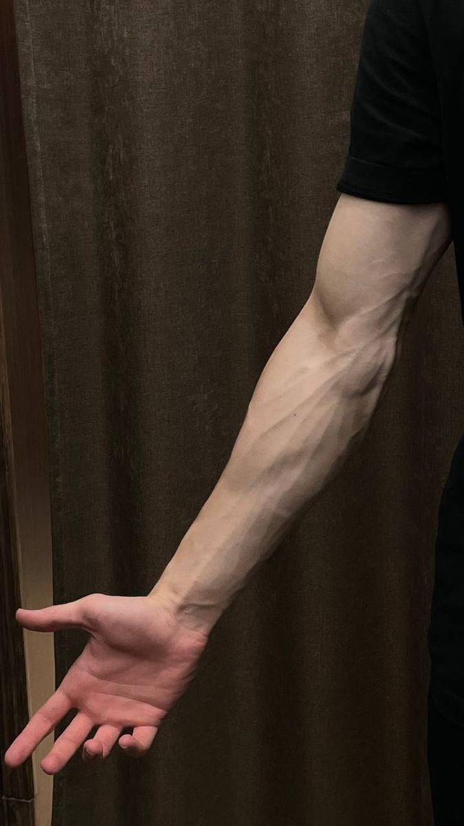 a man's arm and hand in front of a shower curtain, with his hands stretched out to the side