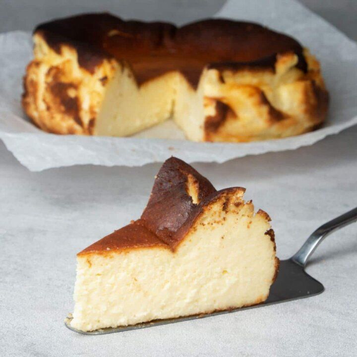 a piece of cheesecake sitting on top of a table next to a slice of cake