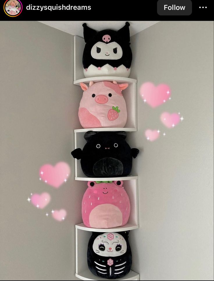 three shelves with stuffed animals and hearts on them