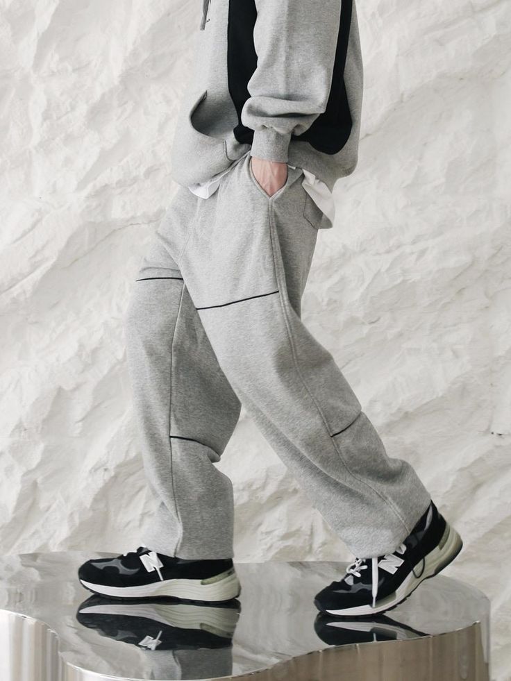 Horizontal piping sweatpants by Moderment are versatile and suitable for casual wear in any setting. You can wear the banding sweatpants comfortably. You can feel the soft and cool touch. - Waistband- Adjustable strap at waist- Piping detail on the front- Comfort fit- Stopper at the hem- Unisex item Gray Tracksuit With Pockets For Loungewear, Gray Cotton Tracksuit For Leisure, Relaxed Fit Cotton Sweatpants With Contrast Stitching, Gray Cotton Relaxed Fit Tracksuit, Gray Relaxed Fit Casual Tracksuit, Sporty Cotton Pants With Contrast Stitching, Sporty Cotton Sweatpants With Contrast Stitching, Sporty Gray Sweats With Elastic Waistband, Casual Tracksuit With Pockets For Jogging