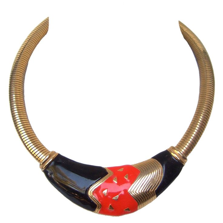 Sleek black & red enamel gilt metal choker style necklace c 1980 The stylish necklace is designed with a bold abstract center plaque The red & black enamel is juxtaposed with gilt metal accents The necklace transitions into wide gilt metal coiled bands that contour around the neck Makes a striking bold accessory The necklace is unsigned The necklace length measures 16" 1/2 inches The enamel center plaque measures 1" inch wide at the widest point Red Choker Necklace, Necklaces Red, Red Choker, Necklace C, Metal Choker, Choker Style Necklace, Choker Jewelry, Bold Accessories, Red Necklace