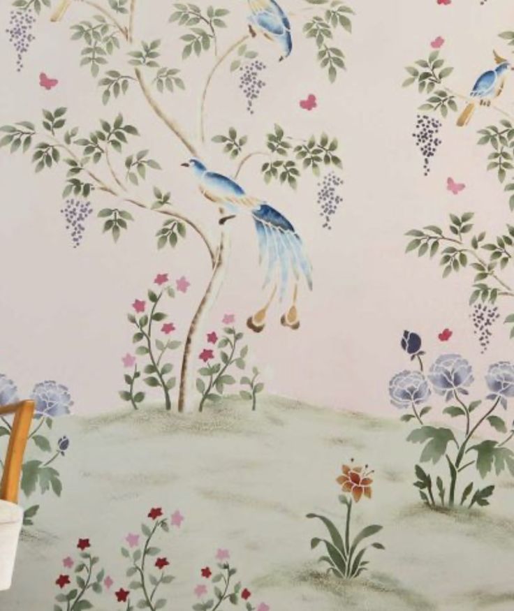 the wallpaper is painted with birds and flowers on it's sides, while another bird flies in the background