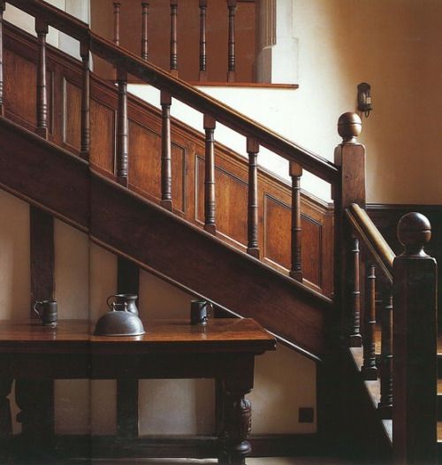 the stairs are made of wood and have wooden balconies