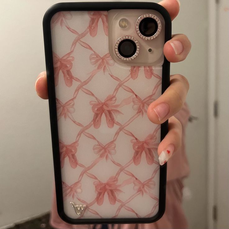 a person holding up a phone case with flowers on it