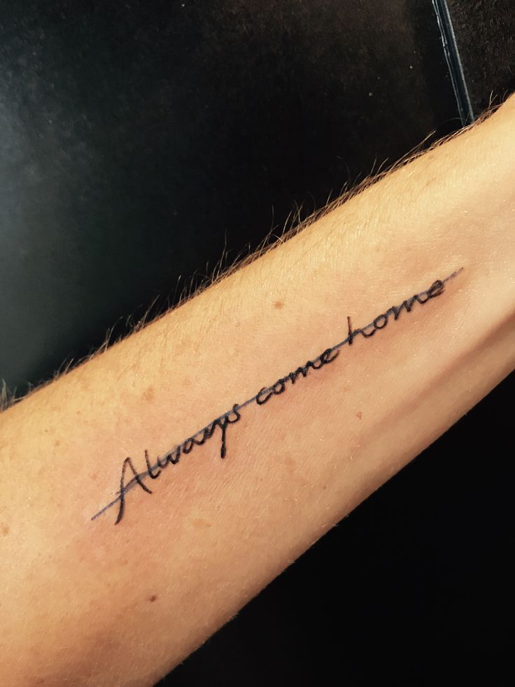 someone with a tattoo that says,'awesome one home'on their left arm