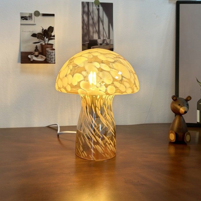 a table with a lamp on it and a bear figurine next to it