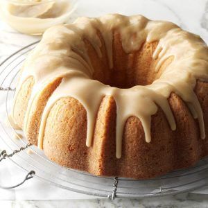 a bundt cake with icing sitting on a cooling rack