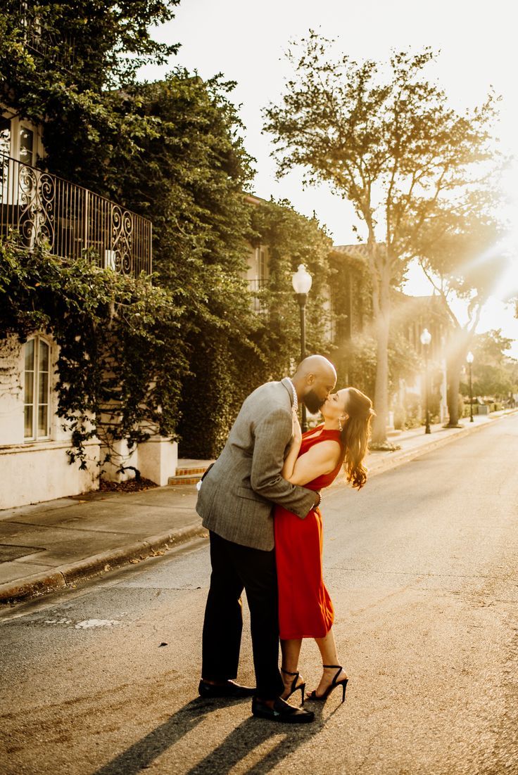 a man and woman kissing on the street