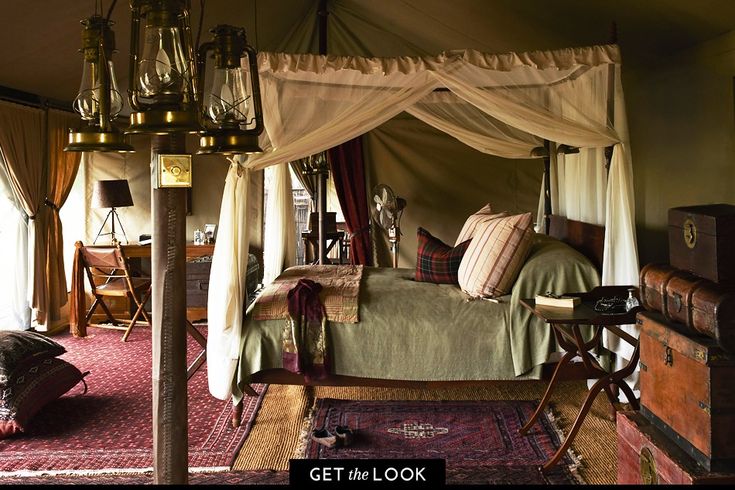 a canopy bed sitting in the middle of a bedroom