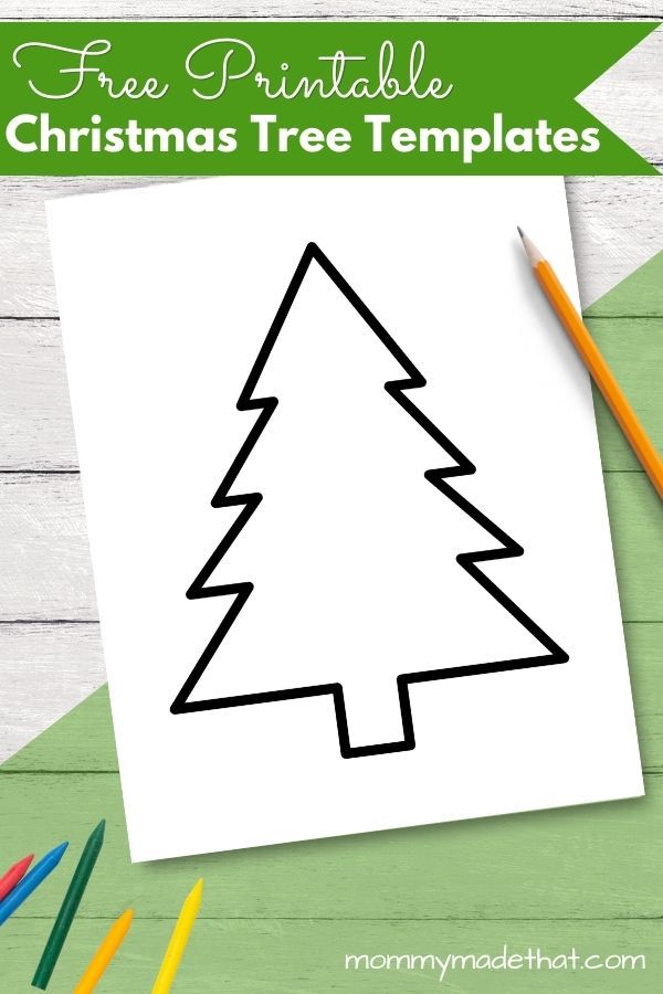 a christmas tree is drawn on a piece of paper with colored pencils next to it