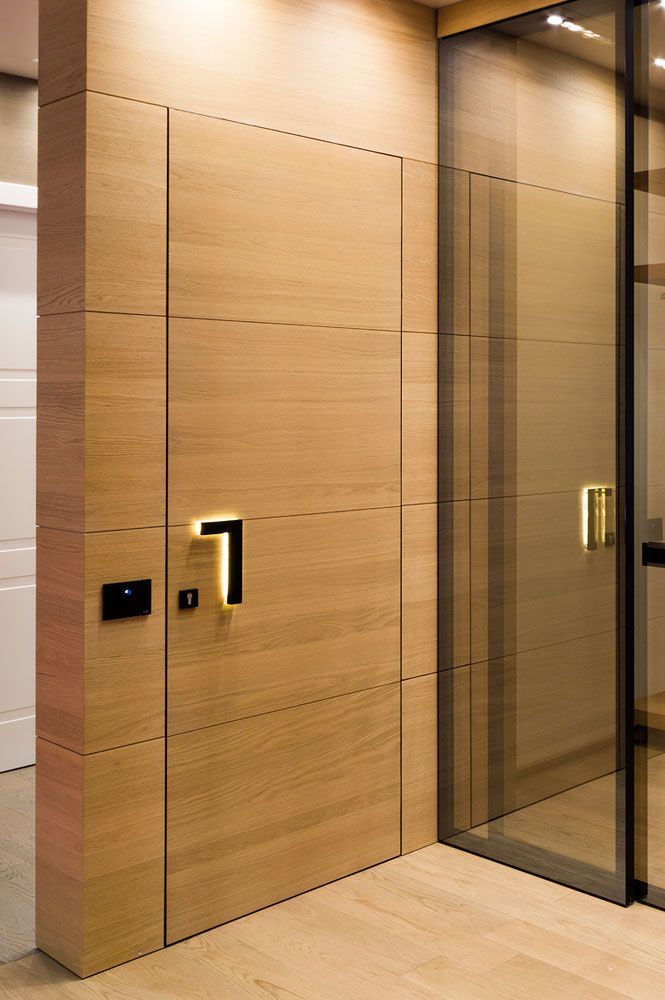 an open glass door in the corner of a room with wooden walls and flooring