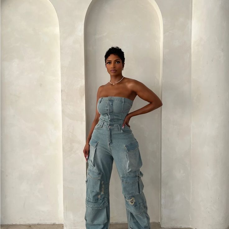 Brand New The Jumpsuit You Didn't Know You Needed! This Denim On Denim Jumpsuit Is The Epitome Of Perfection. With Its Unique Cut And Fit, You’re Sure To Make A Statement In This Set. Its Pre-Cinched Waist And Tailored Fit Make For The Perfect Silhouette. Wear “Jaden” With A Pair Of Heels Or Boots For The Ultimate Fall Vibes. This Jumpsuit Runs Oversized. As It's A Boyfriend Jean Fit. If You Would Like It To Fit Tighter, Size Down When Purchasing. Denim Jumpsuit Photoshoot, Fitted Denim Cargo Jeans For Summer, Fitted Dark Wash Cargo Jeans For Summer, Fitted High Rise Cargo Jeans For Summer, Fitted Blue Cargo Jeans For Spring, Blue Fitted Cargo Jeans For Spring, Fitted Blue Cargo Jeans For Summer, Fitted High Waist Denim Cargo Jeans, Fitted High Waist Light Wash Cargo Jeans