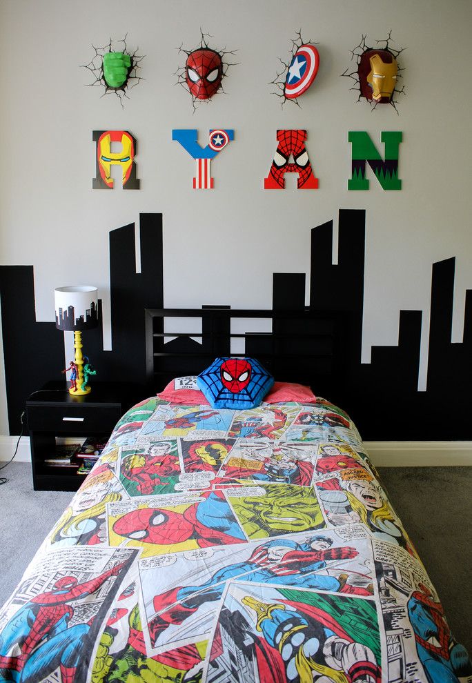 a bed with a spiderman comforter on it in front of a wall decorated with magnets