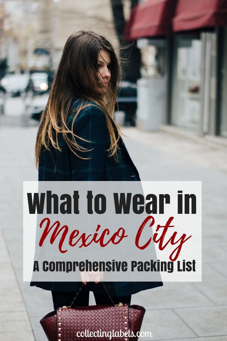 a woman walking down the street holding a sign that says what to wear in mexico city