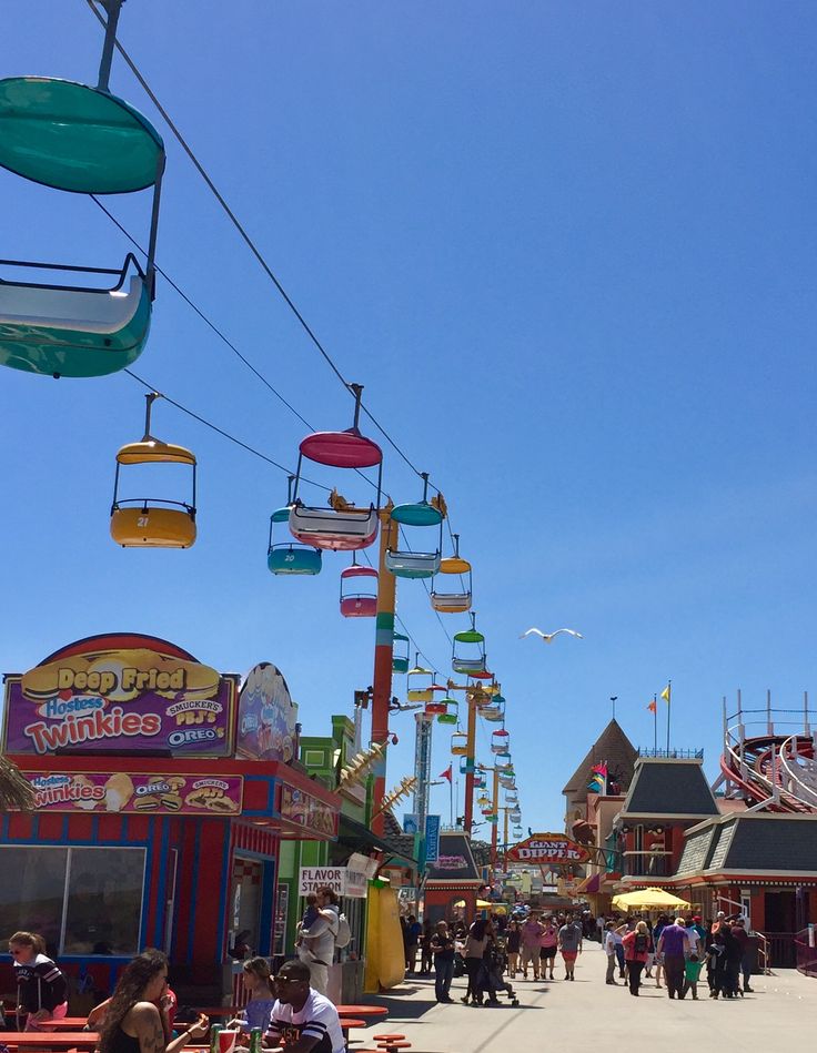 an amusement park with people walking around