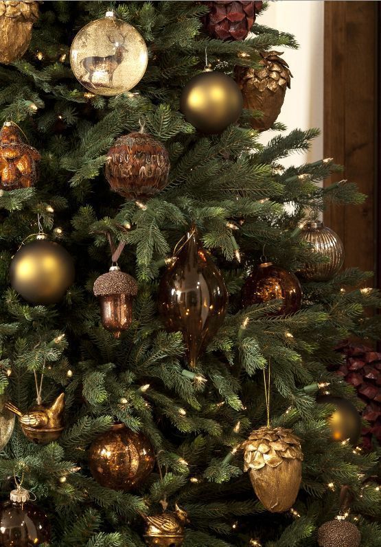 a christmas tree with gold and silver ornaments