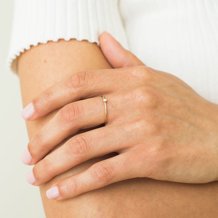 Make your jewelry part of your workout with our Tiny Opal Ring. It's strong enough to stand up to all the sweat while looking beautiful and feminine! Opal is also October's birthstone, so this makes the perfect gift for the October baby in your life! We love it stacked with our Braided Stacking Ring or Simple Stacking Ring. DETAILS 14k gold filled ring 1mm band with 2mm synthetic opal Available in sizes 5-8 Safe for sensitive skin & shower safe Matching jewelry: Tiny Opal Necklace, Tiny Opal Stu Dainty Opal Ring, Simple Stacking Rings, October Baby, Dainty Initial Necklace, Opal Ring Gold, Synthetic Opal, Ball Chain Necklace, Opal Earrings Stud, Opal Studs