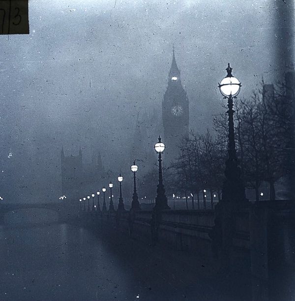 the big ben clock tower towering over the city of london on a foggy day