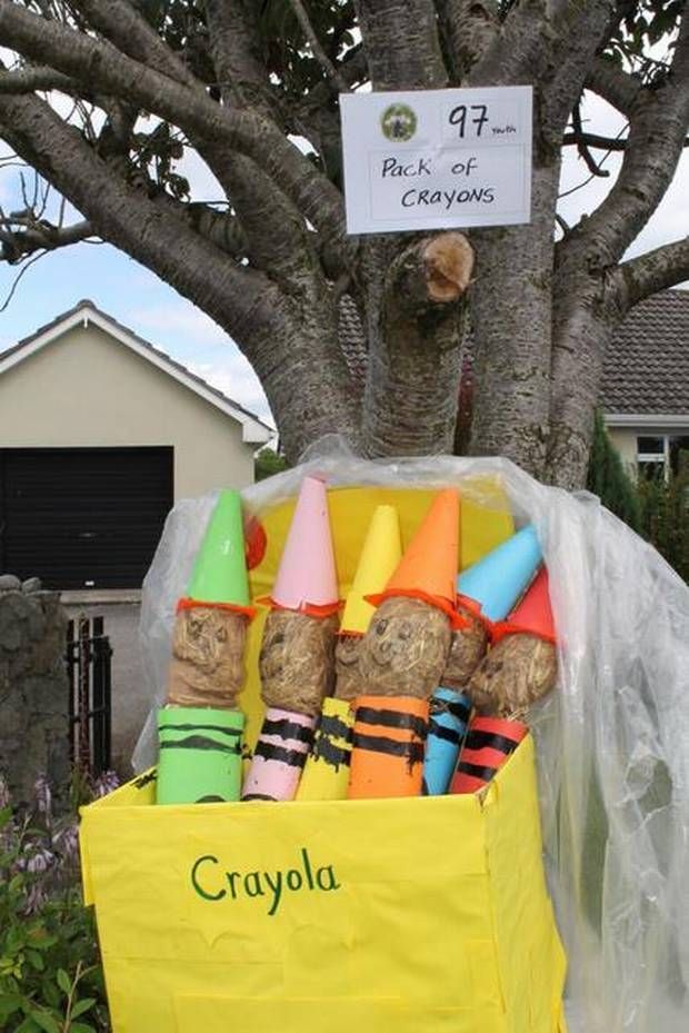 a box filled with crayons sitting next to a tree