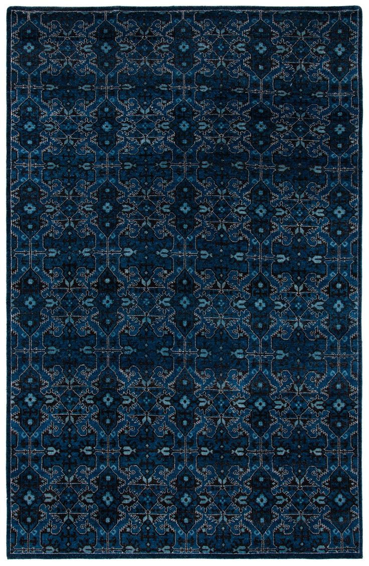 a blue rug with an intricate design on the top and bottom, it is made from wool