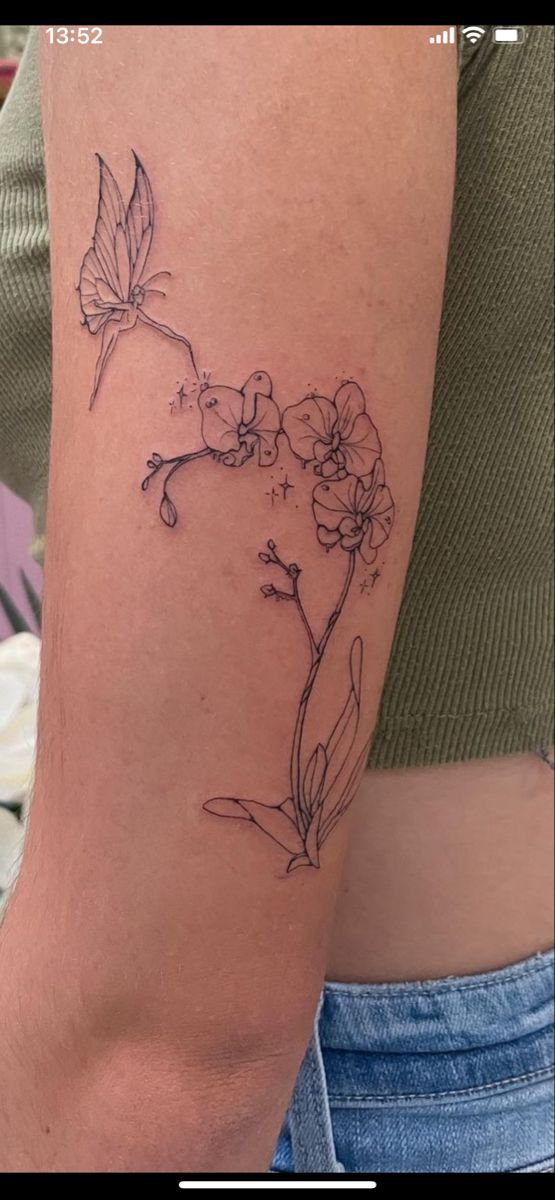 a woman's arm with a flower tattoo on the left side of her arm