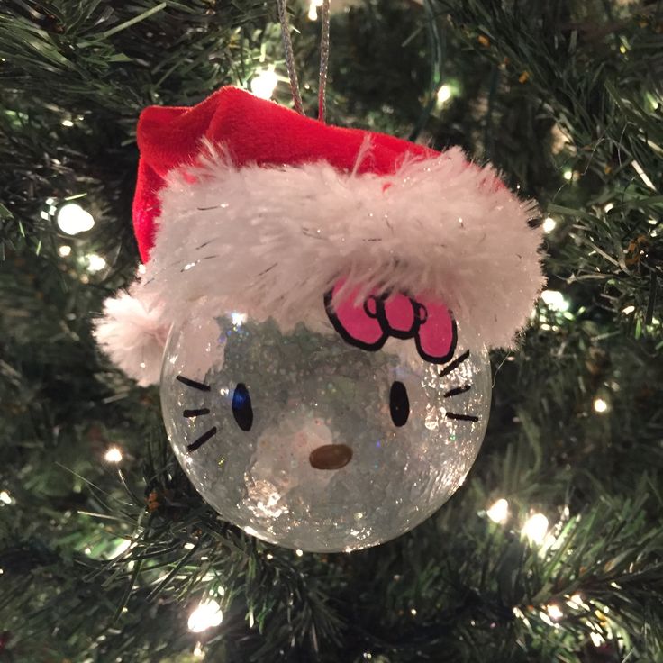 a hello kitty ornament hanging from a christmas tree