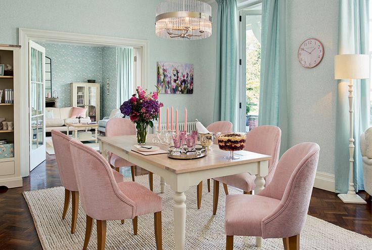 the dining room table is set with pink chairs