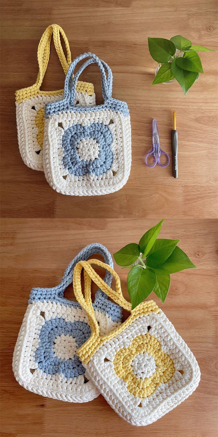 two crocheted purses sitting on top of a wooden table next to a plant