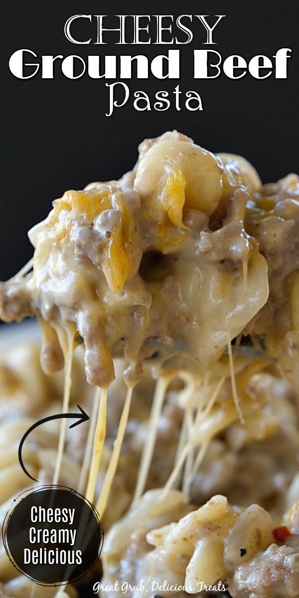 cheesy ground beef pasta is being held up by a fork with cheese on top