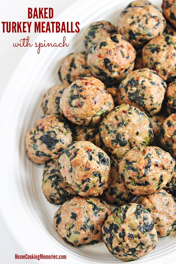 baked turkey meatballs with spinach on a white plate