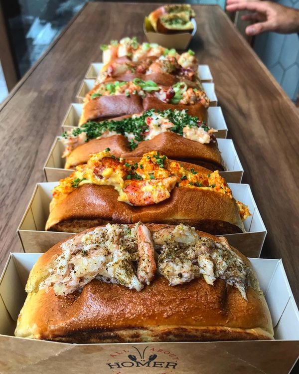 several different types of breads are lined up on a table