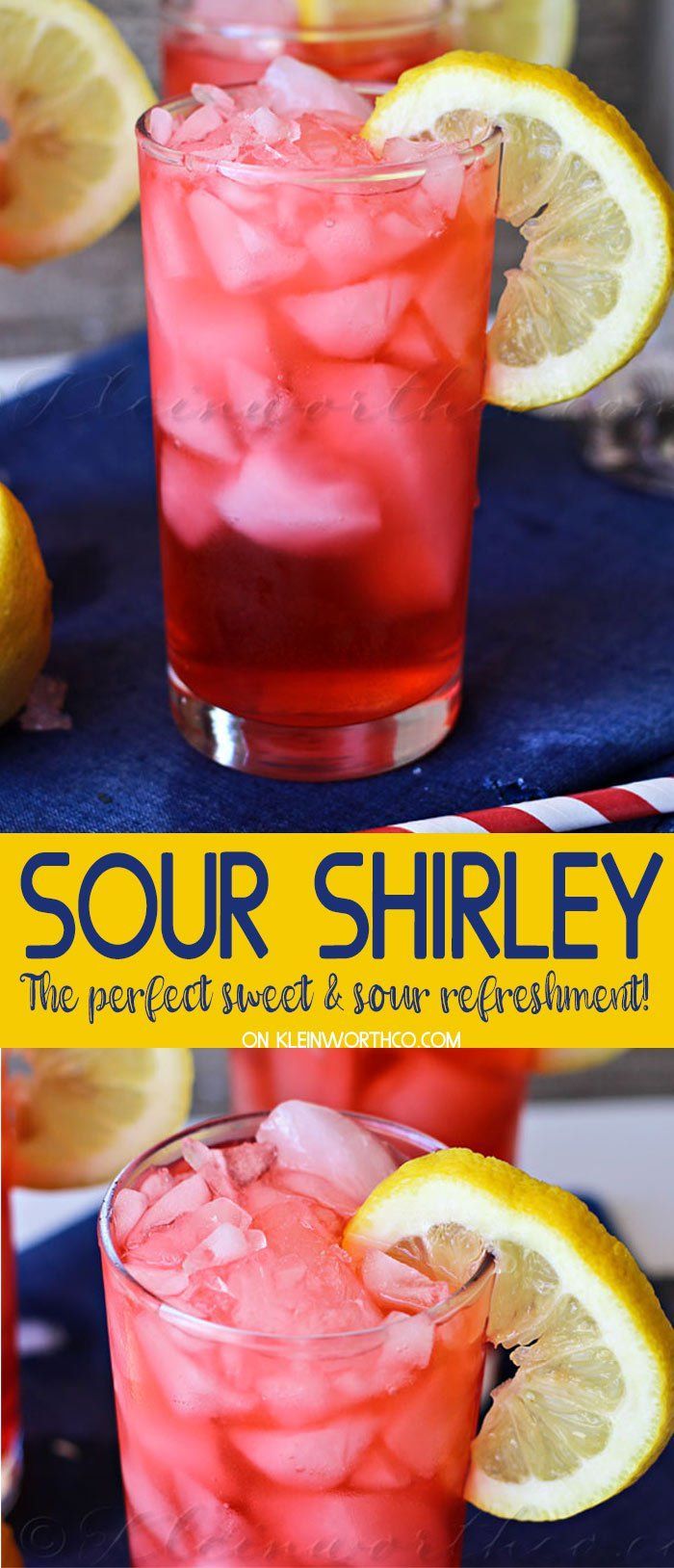 two glasses filled with red liquid and lemons on top of a blue table cloth