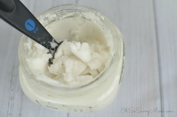 a spoon in a jar filled with whipped cream